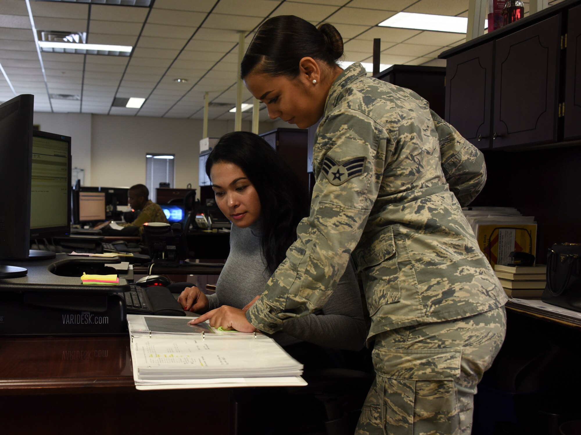 Airman and civilian working together