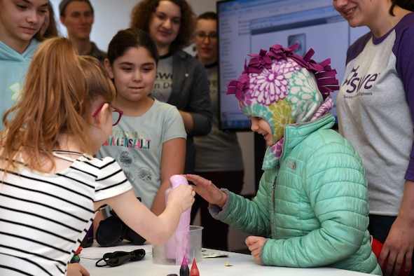Coco Muth, 6, right, touches a foaming mixture resulting from a chemical reaction composed of dish soap, baking soda, water and yeast during a science, technology, engineering and mathematics workshop January 26, 2019, in the Grand Forks Public Library. Muth was one of several children who attended the STEM workshop hosted by Grand Forks Air Force Base, North Dakota, which was designed specifically for mothers to learn alongside their daughters about electrical, mechanical and chemical engineering. (U.S. Air Force photo by Senior Airman Elora J. Martinez)