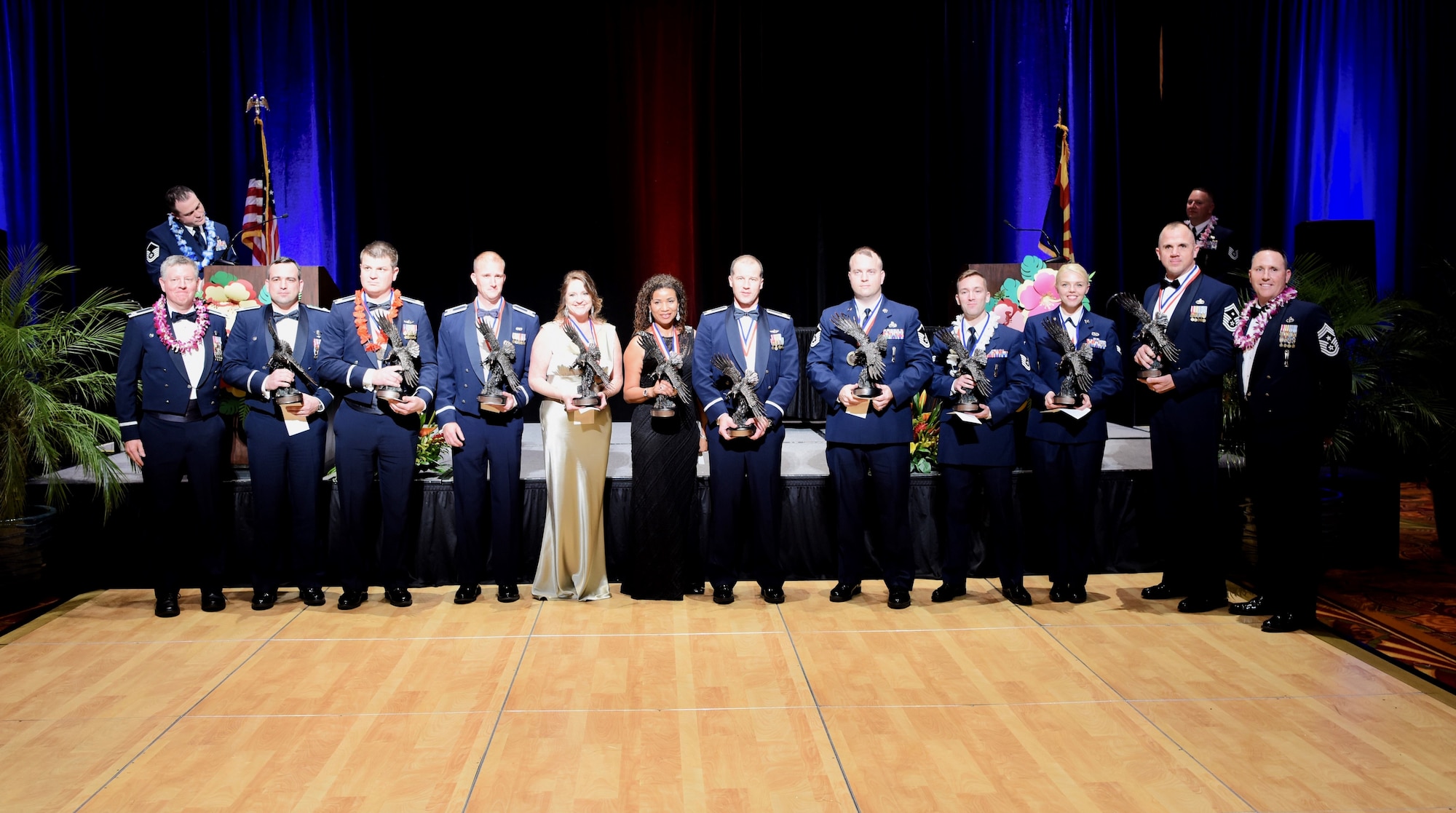 Col. Bryan Cook, 944th Fighter Wing commander and Chief Master Sgt. Jeremy Malcom, 944th FW command chief, stand with the winners of the 944th FW 2018 Annual Award winners Feb. 9, at the Renaissance Hotel, Glendale, Ariz. U.S. Air Force photo by Staff Sgt. Christopher Moore)