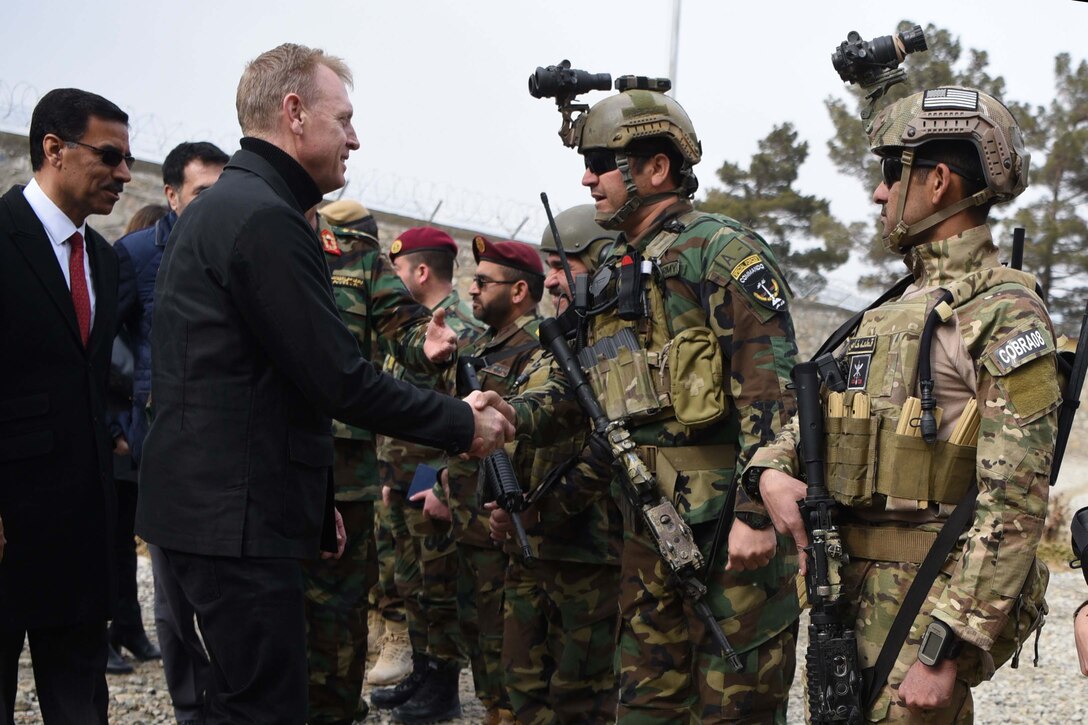 Acting Defense Secretary Patrick M. Shanahan shakes hands with Afghan commandos at Camp Commando, Afghanistan.