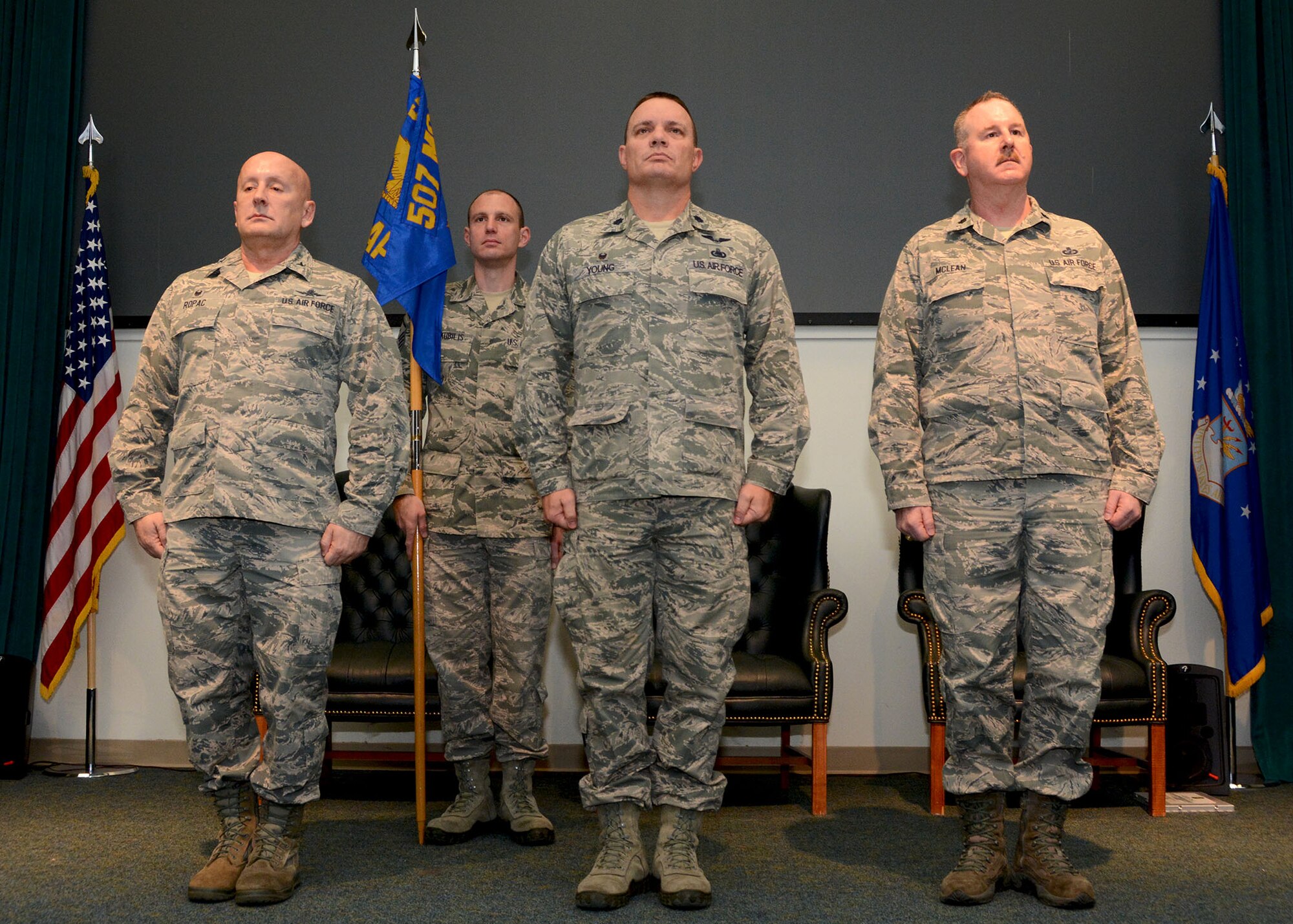Lt. Col. William Young, center, stands before the 72nd Aerial Port Squadron prior to relinquishing command Feb. 10, 2019, at Tinker Air Force Base, Oklahoma. Col. Richard Ropac, left, 507th Mission Support Group commander, transferred the guidon to new commander, Lt. Col. Darryl McLean, moments later. (U.S. Air Force photo by Tech. Sgt. Samantha Mathison)