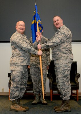 Col. Richard Ropac, 507th Mission Support Group commander, hands the 72nd Aerial Port Squadron guidon Lt. Col. Darryl McLean, Feb. 10, 2019, during a change of command ceremony at Tinker Air Force Base, Oklahoma. (U.S. Air Force photo by Tech. Sgt. Samantha Mathison)