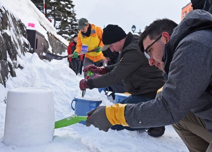Yeoman 3rd Class Thomas Lattanzio, from Nyack, N.Y., builds a snow lantern during a community relations event in support of the Snow Light Path Festival in Otaru, Japan.
