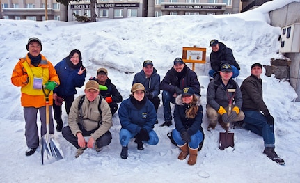 Blue Ridge and 7th Fleet snow lantern event volunteers pose for a group photo with the event coordinators in Otaru, Japan.