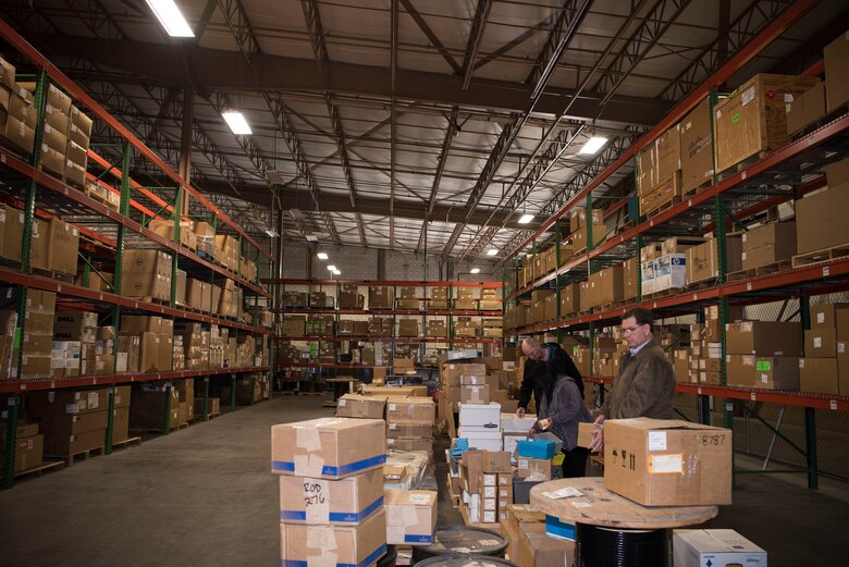 Three 30th Contracting Squadron civilians survey items in a warehouse used for storing government furnished property Feb. 12, 2018, on Vandenberg Air Force Base, Calif. The team is responisble for saving $1 billion over the course of seven years.