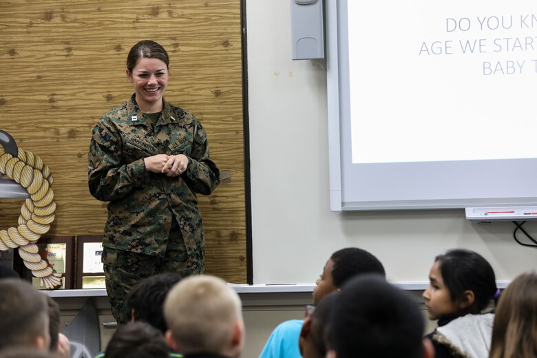 Navy Lt. Kathryn Harrington gives a presentation to students from Kinser Elementary School on oral health Feb. 5, 2019 on Camp Kinser, Okinawa, Japan. Sailors from Naval clinics in Okinawa, held a presentation to promote oral health awareness during National Children’s Dental Health Month. Harrington, a general dentist with Branch Dental Clinic Futenma, 3rd Dental Battalion, 3rd Marine Logistics Group, is a native of Cleveland, Ohio. (U.S. Marine Corps photo by Armando Elizalde)