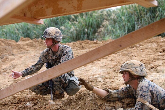 Cpl. William Vincent, left, and Lance Cpl. Bryce Taft inspect damage on a bridge structure Feb. 7, 2019 at Camp Hansen, Okinawa, Japan. Marines with Medium Girder Bridge Platoon, Bridge Company, 9th Engineer Support Battalion, 3rd Marine Logistics Group, repaired then disassembled a bridge they constructed earlier that week to further train in bridge building. Vincent, a combat engineer team leader with MGB Plt., Bridge Co., 9th ESB, 3rd MLG, is a native of Springfield, Illinois. Taft, a combat engineer fire team leader with MGB Plt., Bridge Co., 9th ESB, 3rd MLG, is a native of Maricopa, Arizona. (U.S. Marine Corps photo by Lance Cpl. Ryan Harvey)
