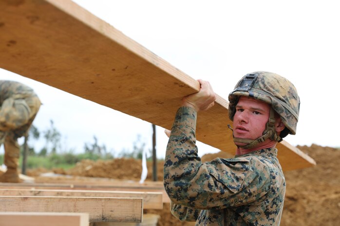 Cpl. William Vincent removes a 16-foot floor board from a bridge Feb. 7, 2019 at Camp Hansen, Okinawa, Japan. Marines with Medium Girder Bridge Platoon, Bridge Company, 9th Engineer Support Battalion, 3rd Marine Logistics Group, repaired then disassembled a bridge they constructed earlier that week to further train in bridge building. Vincent, a combat engineer team leader with MGB Plt., Bridge Co., 9th ESB, 3rd MLG, is a native of Springfield, Illinois. (U.S. Marine Corps photo by Lance Cpl. Ryan Harvey)