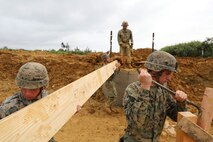 Marines with Medium Girder Bridge Platoon, Bridge Company, 9th Engineer Support Battalion, 3rd Marine Logistics Group work together to deconstruct their bridge on their final training day Feb. 7, 2019 at Camp Hansen, Okinawa, Japan. The platoon repaired then disassembled a bridge they constructed earlier that week to further train in bridge building. (U.S. Marine Corps photo by Lance Cpl. Ryan Harvey)