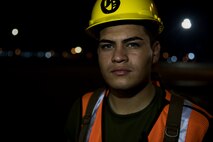 Lance Cpl. Roy Gamon waits to ground guide a vehicle on the port during a maritime prepositioning force (MPF) offload of the U.S.N.S. Pililaau (TAKR-304) for Cobra Gold 19 Feb. 3, 2019 at Laem Chabang Commercial Port, Thailand. The Pililaau is a Marine Corps MPF ship used to deliver Marine assets to areas in the Indo-Pacific region. Gamon, a landing support specialist with Combat Logistics Detachment 332, Combat Logistics Regiment 3, 3rd Marine Logistics Group, is a native of Los Angeles, California. (U.S. Marine Corps photo by Cpl. Jamin M. Powell)