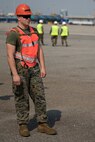 Cpl. Hunter Mayle waits to ground guide a vehicle down the ramp of the U.S.N.S. Pililaau (TAKR-304) during a maritime prepositioning force (MPF) offload for Cobra Gold 19 Feb. 3, 2019 at Laem Chabang Commercial Port, Thailand. The Pililaau is a Marine Corps MPF ship used to deliver Marine assets to areas in the Indo-Pacific region. Mayle, a generator Mechanic with Combat Logistics Detachment 332, Combat Logistics Regiment 3, 3rd Marine Logistics Group, is a native of Morgantown, West Virginia. (U.S. Marine Corps photo by Cpl. Jamin M. Powell)