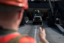 Cpl. Hunter Mayle Ground guides a vehicle down the ramp of the U.S.N.S. Pililaau (TAKR-304) during a maritime prepositioning force (MPF) offload for Cobra Gold 19 Feb. 3, 2019 at Laem Chabang Commercial Port, Thailand. The Pililaau is a Marine Corps MPF ship used to deliver Marine assets to areas in the Indo-Pacific region. Mayle, a generator Mechanic with Combat Logistics Detachment 332, Combat Logistics Regiment 3, 3rd Marine Logistics Group, is a native of Morgantown, West Virginia. (U.S. Marine Corps photo by Cpl. Jamin M. Powell)