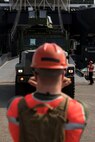 Cpl. Hunter Mayle Ground guides a vehicle down the ramp of the U.S.N.S. Pililaau (TAKR-304) during a maritime prepositioning force (MPF) offload for Cobra Gold 19 Feb. 3, 2019 at Laem Chabang Commercial Port, Thailand. The Pililaau is a Marine Corps MPF ship used to deliver Marine assets to areas in the Indo-Pacific region. Mayle, a generator Mechanic with Combat Logistics Detachment 332, Combat Logistics Regiment 3, 3rd Marine Logistics Group, is a native of Morgantown, West Virginia. (U.S. Marine Corps photo by Cpl. Jamin M. Powell)
