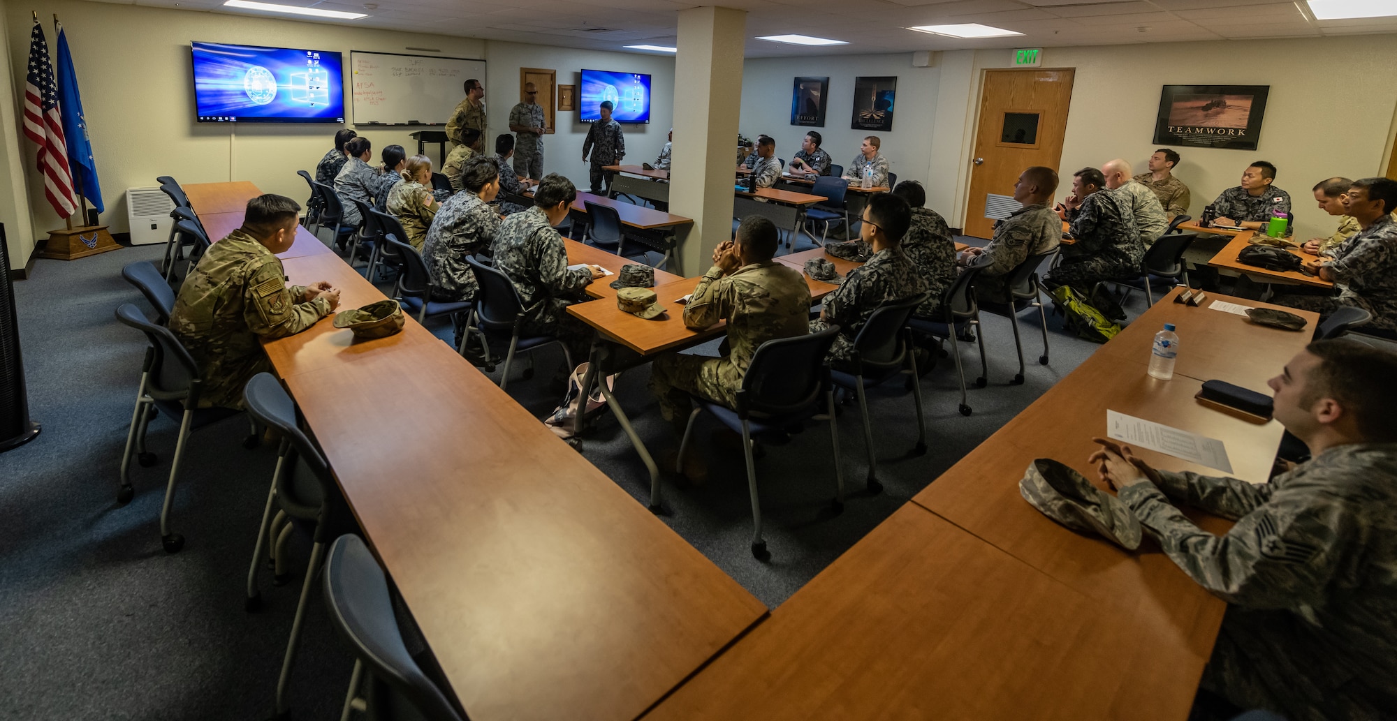 Japan Air Self-Defense Force Airmen and U.S. service members listen to a briefing Nov. 19, 2018, during the 2018 Bilateral Exchange at Kadena Air Base, Japan. The event included professional enhancement seminars, physical training, a tour of an MC-130H Combat Talon II, an infiltration and exfiltration demonstration, a historical tour and team building exercises. (U.S. Air Force photo by Staff Sgt. Micaiah Anthony)