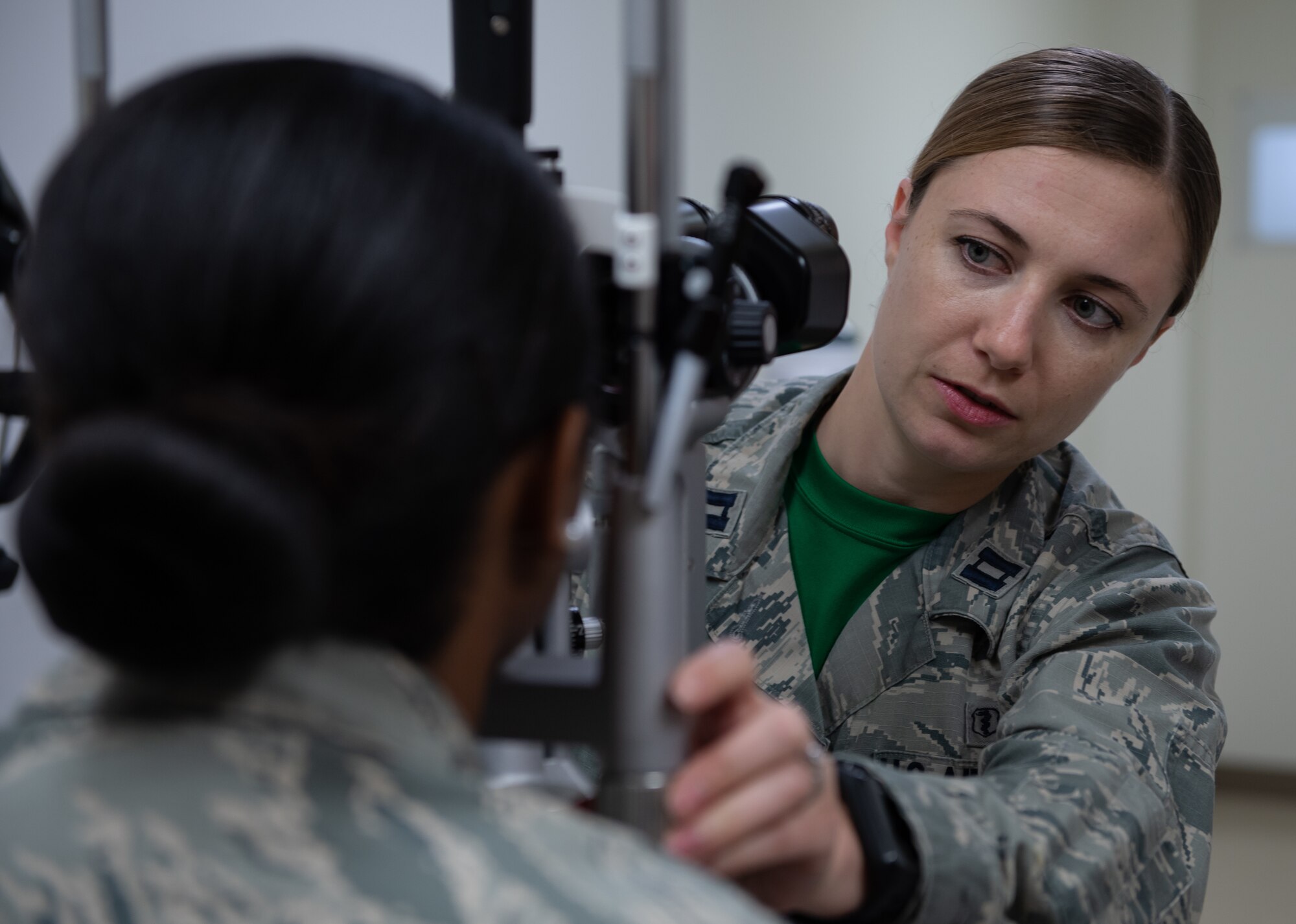 U.S. Air Force Capt. Suzanne Romeo, 18th Aerospace Medicine Squadron operational optometry chief, prepares to conduct an eye exam on Airman 1st Class Praise Butler-Davis, 18th AMDS optometry technician, Jan. 11, 2019, at Kadena Air Base, Japan. Optometrists provide primary eye care by testing people’s eyes for visual acuity and eye diseases. (U.S. Air Force photo by Staff Sgt. Micaiah Anthony)