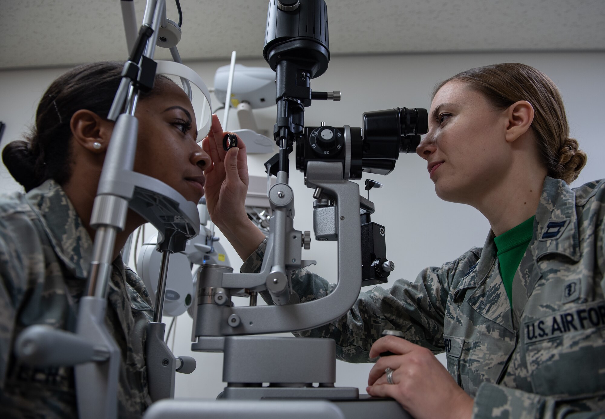 U.S. Air Force Capt. Suzanne Romeo, 18th Aerospace Medicine Squadron operational optometry chief, conducts an exam on Airman 1st Class Praise Butler-Davis, 18th AMDS optometry technician, Jan. 11, 2019, at Kadena Air Base, Japan. Optometrists provide primary eye care by testing people’s eyes for visual acuity and eye diseases. (U.S. Air Force photo by Staff Sgt. Micaiah Anthony)