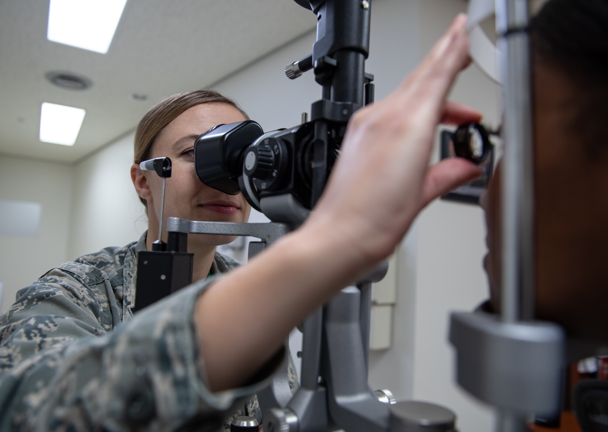 U.S. Air Force Capt. Suzanne Romeo, 18th Aerospace Medicine Squadron operational optometry chief, conducts an eye exam on Airman 1st Class Praise Butler-Davis, 18th AMDS optometry technician, Jan. 11, 2019, at Kadena Air Base, Japan. Optometrists are one of several positions in the Biomedical Sciences Corps. To honor these professionals the Air Force has designated Jan. 28 through Feb. 1, as BSC week. (U.S. Air Force Staff Sgt. Micaiah Anthony)