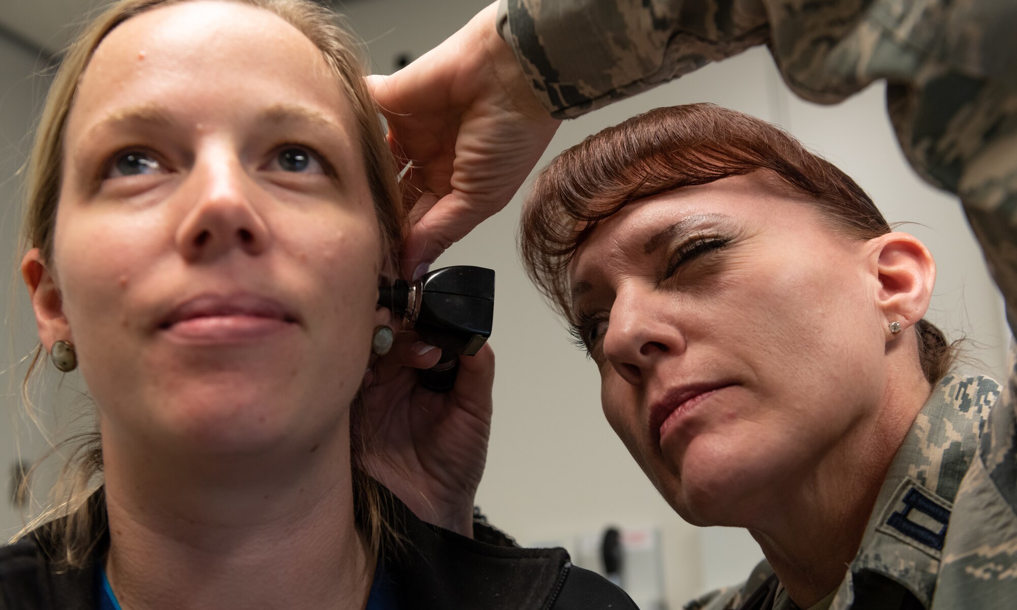 U.S. Air Force Capt. Andrea Tidd, 18th Medical Services Flight commander and physician assistant, examines the ear of Deana Ladd, 18th Medical Group registered nurse, Jan. 23, 2019, at Kadena Air Base, Japan. Physician assistants often serve as a patient’s principal healthcare provider. Their role in patient care consists of diagnosing illnesses, developing and managing treatment plans and prescribing medications. (U.S. Air Force photo by Staff Sgt. Micaiah Anthony)