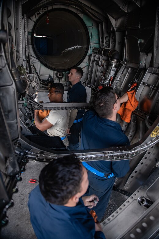 U.S. Air Force Airmen from the 18th Aircraft Maintenance Squadron clean an F-15 Eagle engine bay compartment, Jan. 18, 2019, at Kadena Air Base, Japan. Airmen from the 18th AMXS cleaned the engine bay to help them identify and repair cracks and gouges. (U.S. Air Force photo by Staff Sgt. Micaiah Anthony)