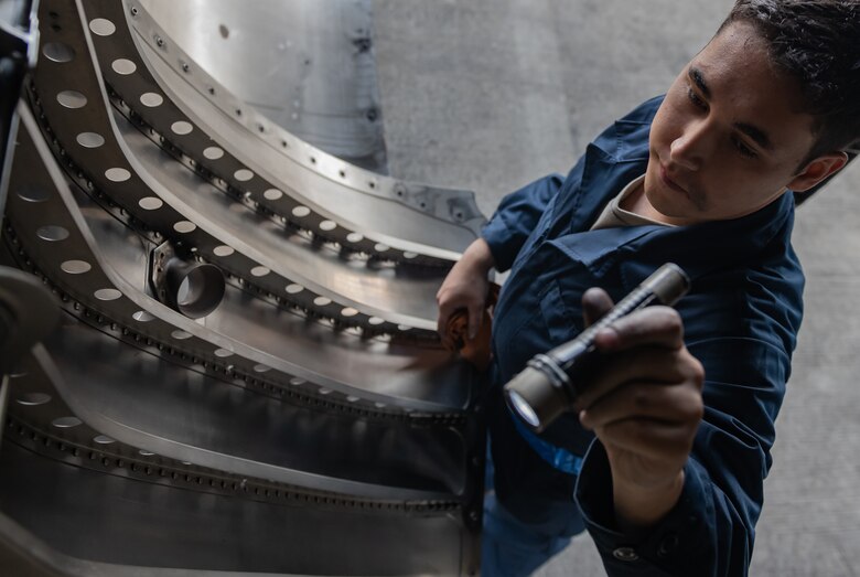 U.S. Air Force Airman 1st Class Jack O’Connell, 18th Aircraft Maintenance Squadron crew chief, inspects an F-15 Eagle engine bay compartment, Jan. 18, 2019, on Kadena Air Base, Japan. Airmen from the 18th AMXS cleaned the engine bay to help them identify and repair cracks and gouges. (U.S. Air Force photo by Staff Sgt. Micaiah Anthony)