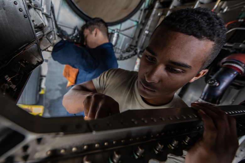 U.S. Air Force Airman 1st Class Nathaniel West, 18th Aircraft Maintenance Squadron crew chief, cleans an F-15 Eagle engine bay compartment, Jan. 18, 2019, on Kadena Air Base, Japan. Over time, dirt, grease and grime can build up in the aircrafts engine bay and can cover up cracks or other discrepancies on the aircraft. (U.S. Air Force photo by Staff Sgt. Micaiah Anthony)