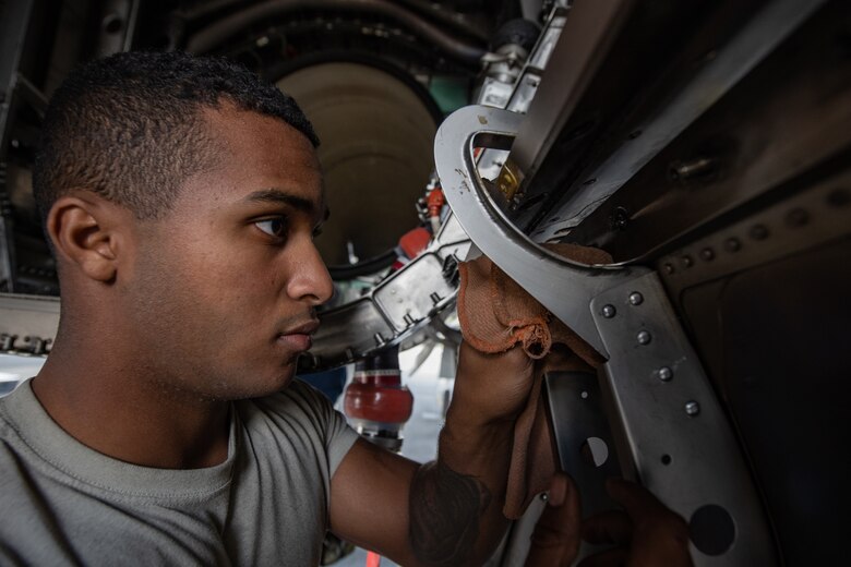 U.S. Air Force Airman 1st Class Nathaniel West, 18th Aircraft Maintenance Squadron crew chief, cleans an F-15 Eagle engine bay compartment, Jan. 18, 2019, on Kadena Air Base, Japan. The F-15 Eagle is powered by two turbofan engines that are capable of producing 23,450 pounds of thrust per engine.  (U.S. Air Force photo by Staff Sgt. Micaiah Anthony)