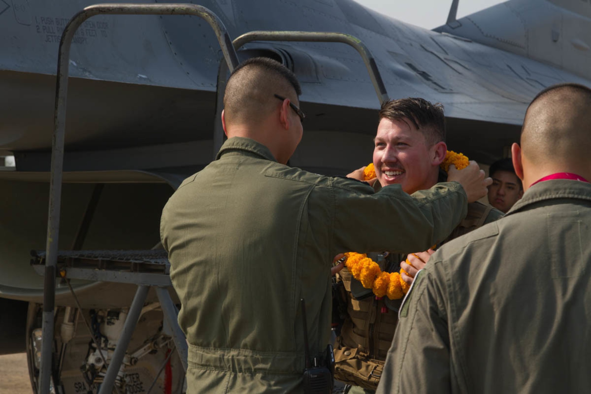 U.S. Air Force 1st Lt. Cameron Fierro, 35th Fighter Squadron pilot, greets Royal Thai Air Force squadron leader Suppawath Boonarch for Exercise Cobra Gold 2019 at Korat Royal Thai Air Force Base, Thailand, Feb. 6 2019.