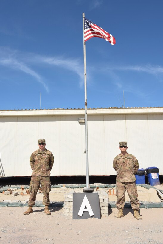 Private 1st Class Matthew Burke, Bravo Battery, 1st Battalion, 43rd Air Defense Artillery Regiment in charge of Bravo Command Post records, and Specialist Casey Bearden, B/1-43 ADA enhanced early warning systems operator, pose for a photo at Al Dhafra Air Base, United Arab Emirates, Jan. 12, 2019.