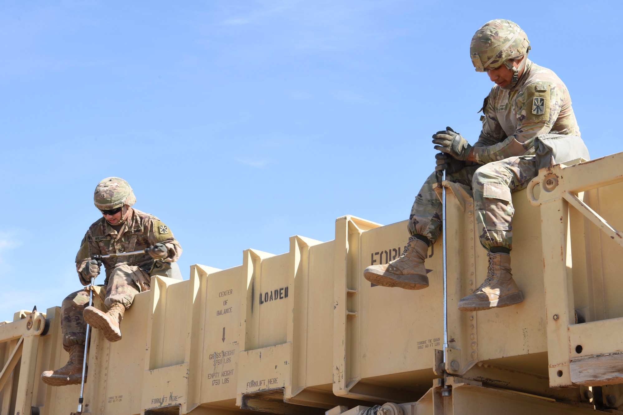 Private 1st Class Benjamin Williams, Bravo Battery, 1st Battalion, 43rd Air Defense Artillery Regiment Patriot launcher enhanced operator and maintainer crew member 1, and Specialist Eduardo Martinez, 1-43 ADA Patriot launcher enhanced operator and crew member 2, torque down cans during training at Al Dhafra Air Base, United Arab Emirates, Jan. 12, 2019.