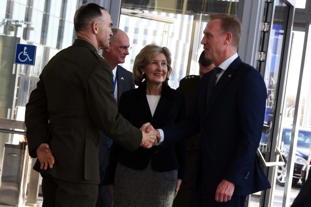 Acting Defense Secretary Patrick M. Shanahan greets Marine Corps Lt. Gen. John K. Love, the senior military representative to NATO.