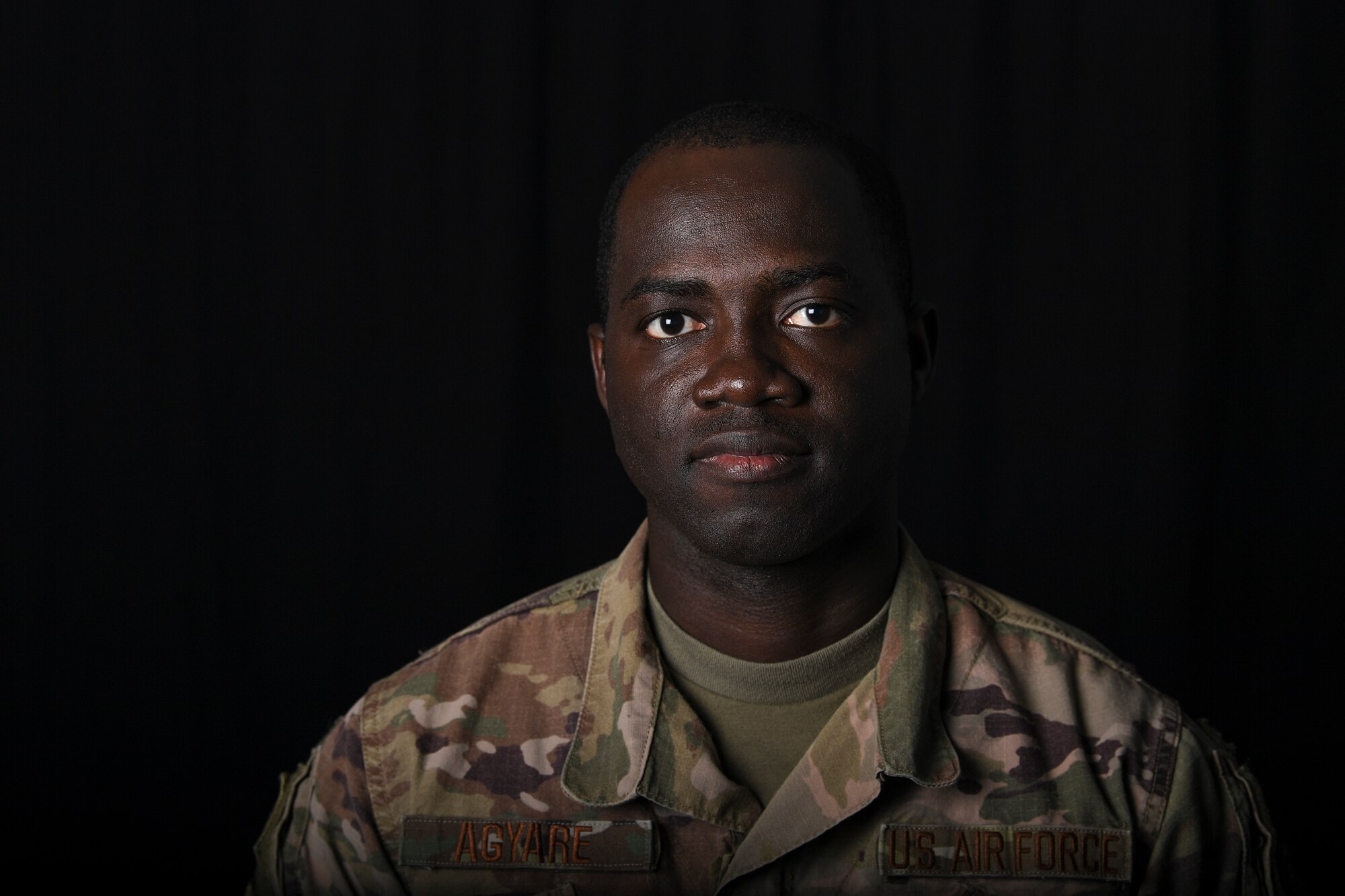 U.S. Air Force Senior Airman Theophilus Agyare, 380th Expeditionary Contracting Squadron contracting officer, poses for a photo at Al Dhafra Air Base, United Arab Emirates, Jan. 17, 2019. In 2014, Agyare received a visa and left his home country, to fulfill his childhood dream of being in the military while supporting his family back home in Ghana. (U.S. Air Force photo by Senior Airman Mya M. Crosby)