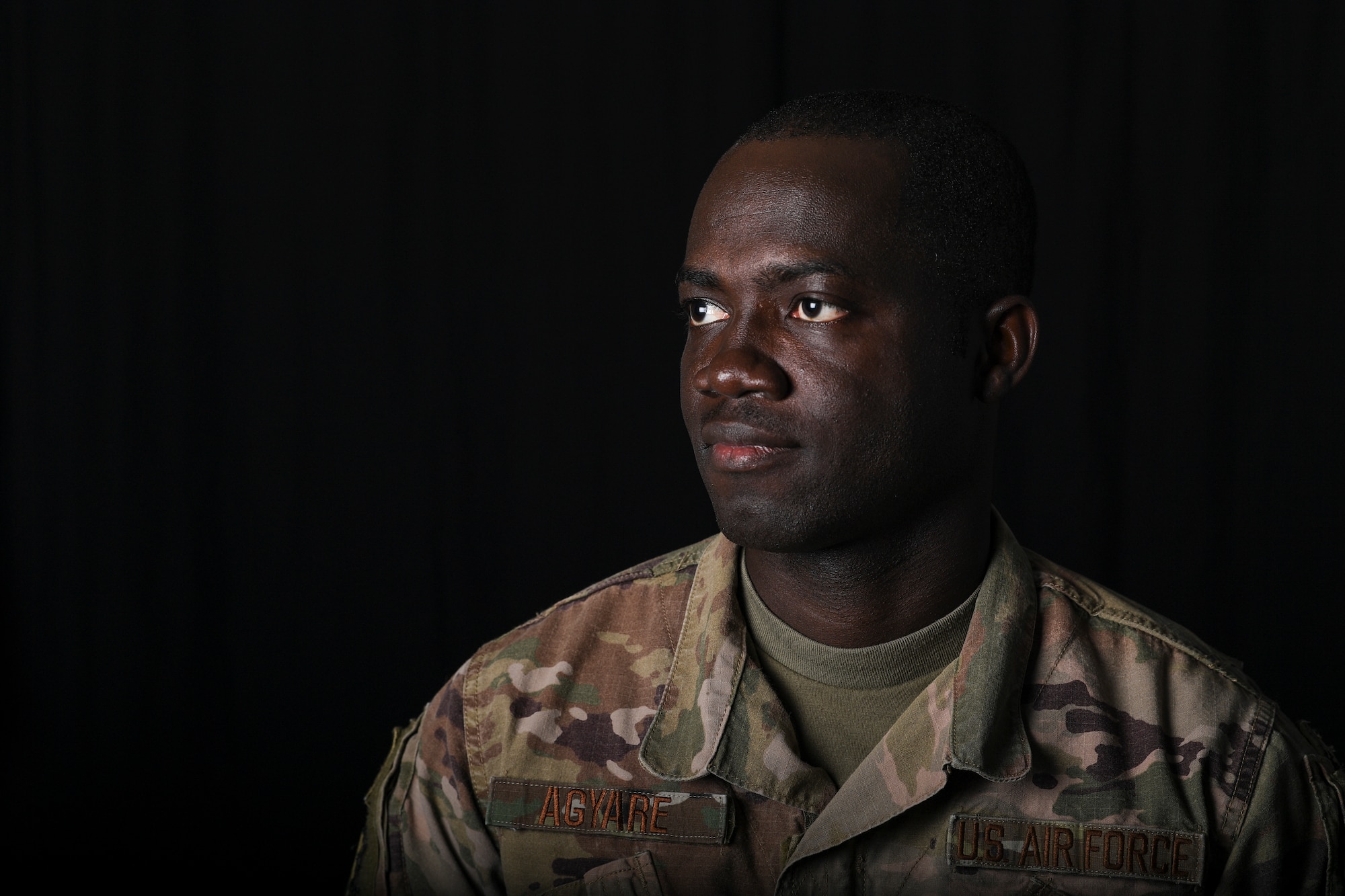 U.S. Air Force Senior Airman Theophilus Agyare, 380th Expeditionary Contracting Squadron contracting officer, poses for a photo at Al Dhafra Air Base, United Arab Emirates, Jan. 17, 2019. In 2014, Agyare received a visa and left his home country, to fulfill his childhood dream of being in the military while supporting his family back home in Ghana. (U.S. Air Force photo by Senior Airman Mya M. Crosby)