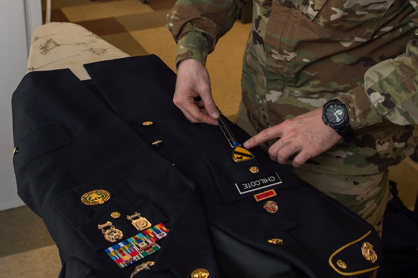 U.S. Army Staff Sgt. Sean Chilcote, Alpha Company, 1st Battalion, 210th Aviation Regiment, 128th Avn. Brigade drill sergeant, checks over his uniform at Joint Base Langley-Eustis, Virginia, Feb. 6, 2019.