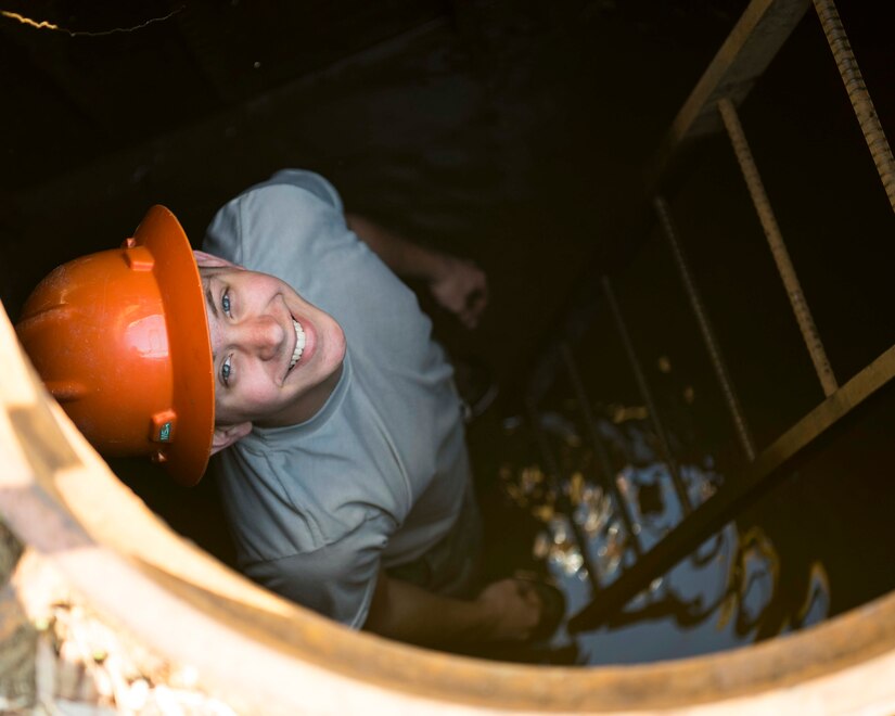 U.S. Air Force Airman 1st Class Jordan Reeve, 633rd Communication Squadron cable and antenna technician, smiles after completing his routine cable inspections in a manhole on Joint Base Langley-Eustis, Virginia, February 8, 2019.