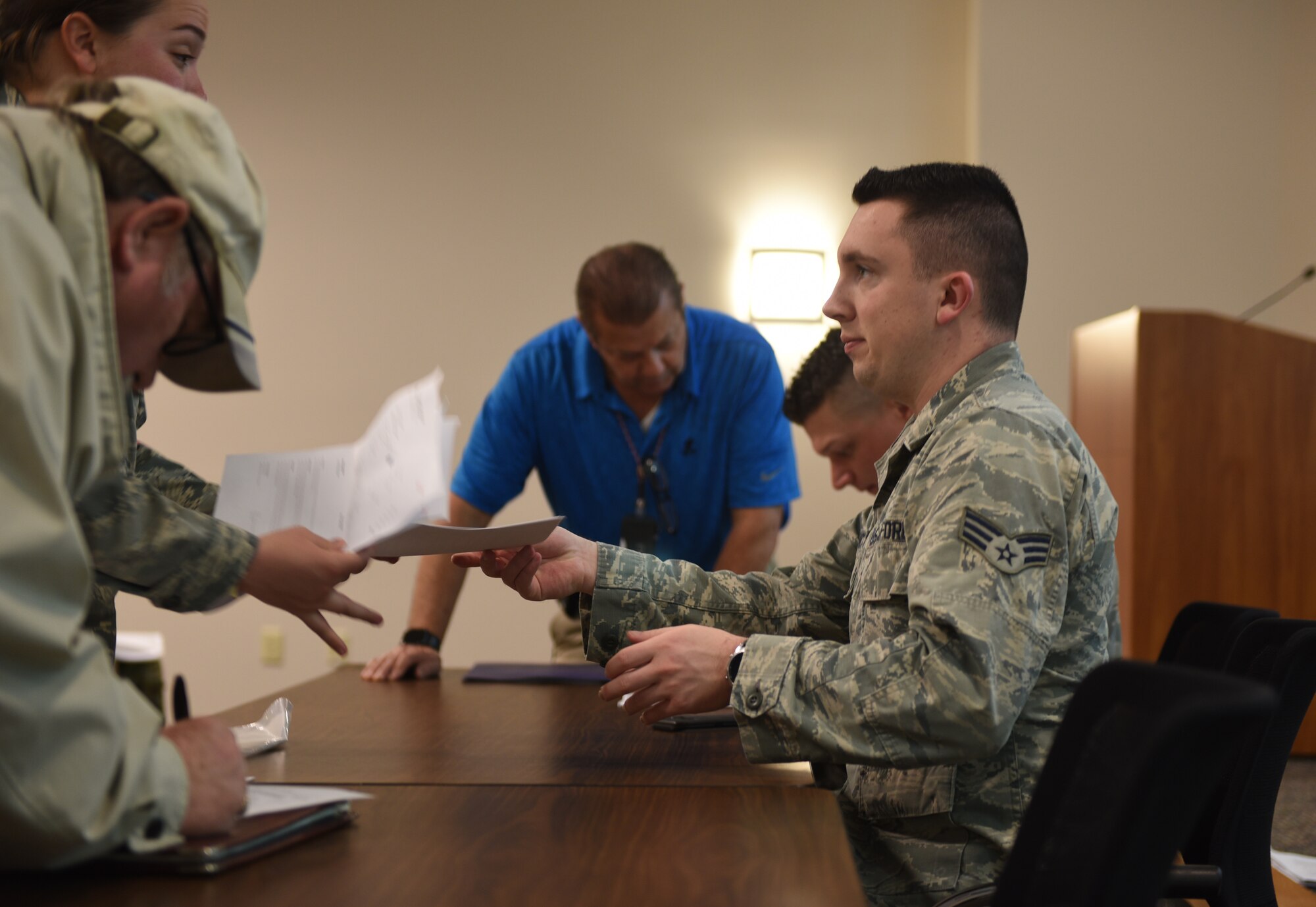 Airman handing customer paperwork