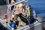 BU1 Justin Lewis and ND2 Kent Knudson of the Navy Experimental Diving Unit give direction to members of the Montenegrin Navy as part of a recent Humanitarian Mine Action Underwater Explosive Remnants of War Clearance Program collaboration.