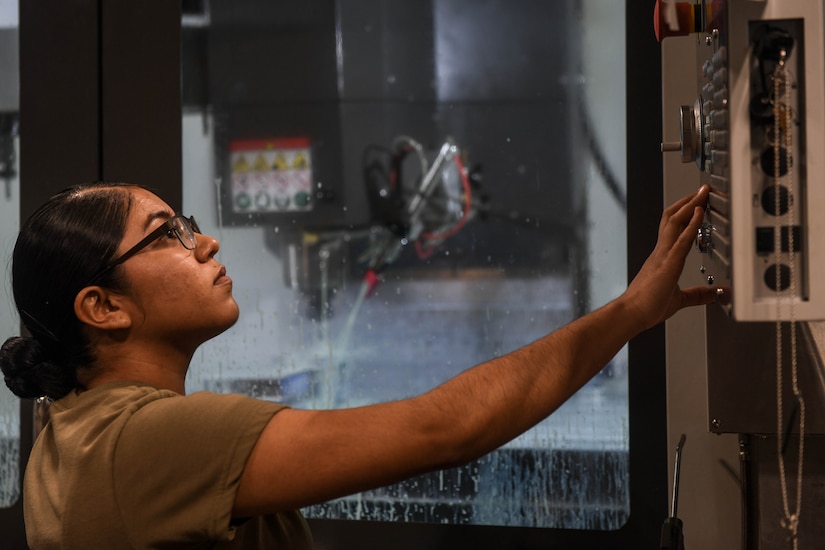 U.S. Army Pfc. Alondra Vazquez, 558th Transportation Company, 10th Trans. Battalion, 7th Trans. Brigade (Expeditionary) allied trade specialist, prepares the Computer Numeric Control machine for startup at Joint Base Langley-Eustis, Virginia, Jan. 23, 2019. The CNC machine is operated by programs that tell it the exact measurements and angles the machine needs to cut for a specific part. (U.S. Air Force photo by Senior Airman Derek Seifert)