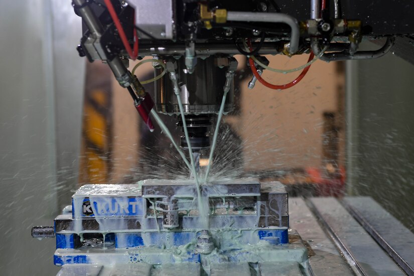 The Computer Numeric Control machine sprays coolant during an operation to prevent overheating and tool damage at Joint Base Langley-Eustis, Virginia, Jan. 23, 2019. The U.S. Army introduced the CNC machine to the force in 2006 to the Warrant Officer allied trade course. (U.S. Air Force photo by Senior Airman Derek Seifert)