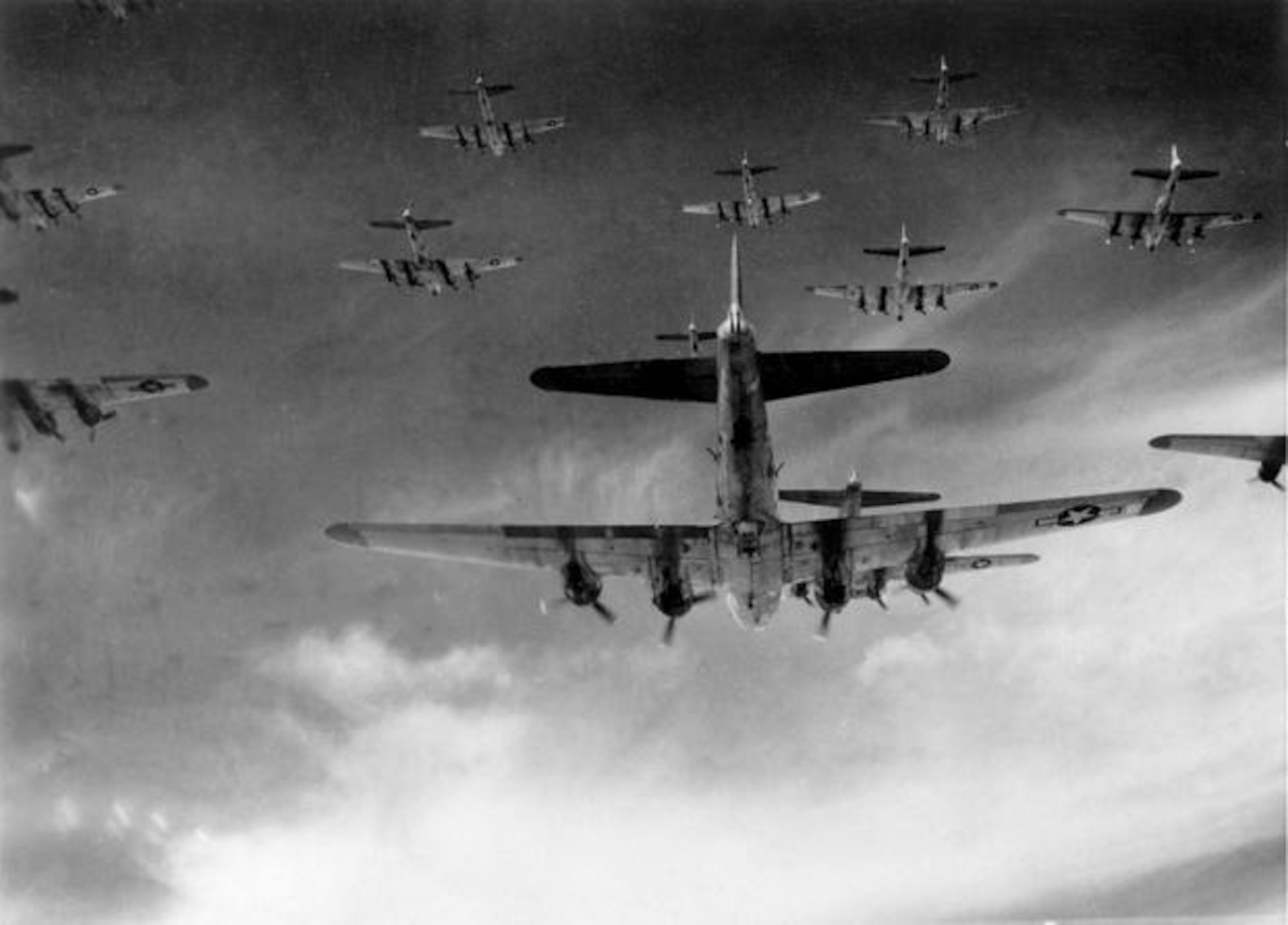 A formation of B-17 Flying Fortress aircraft on the way to bomb industrial targets in Germany, early 1944. Starting in late 1942 through October 1943, B-17s, along with B-24 Liberator strategic bombers conducted unescorted daylight precision bombing raids on German industrial targets. However, these raids temporarily ceased after the disastrous unescorted raids in August and October 1943 produced unsustainable aircraft and aircrew losses. (U.S. Air Force photo)