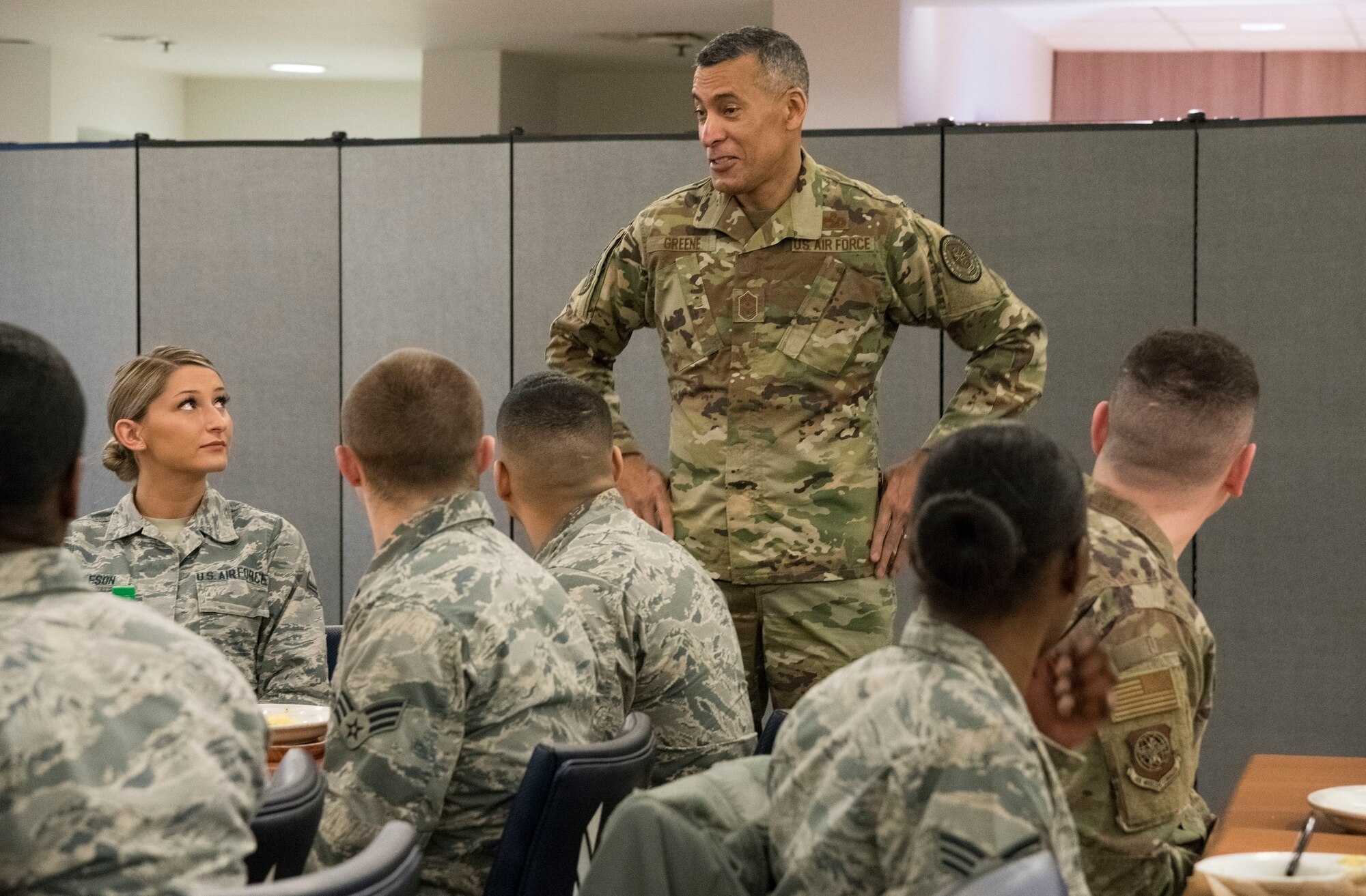U.S. Air Force Chief Master Sgt. Terrence Greene, command chief of Air Mobility Command, Scott Air Force Base, Ill., speaks to Airmen Feb. 7, 2019, at the Patterson Dining Facility on Dover Air Force Base, Del. Airman 1st Class Tess Burleson (left), 436th Aerospace Medicine Squadron dental assistant, looks at Greene as he speaks to her and other Airmen during breakfast. (U.S. Air Force photo by Roland Balik)