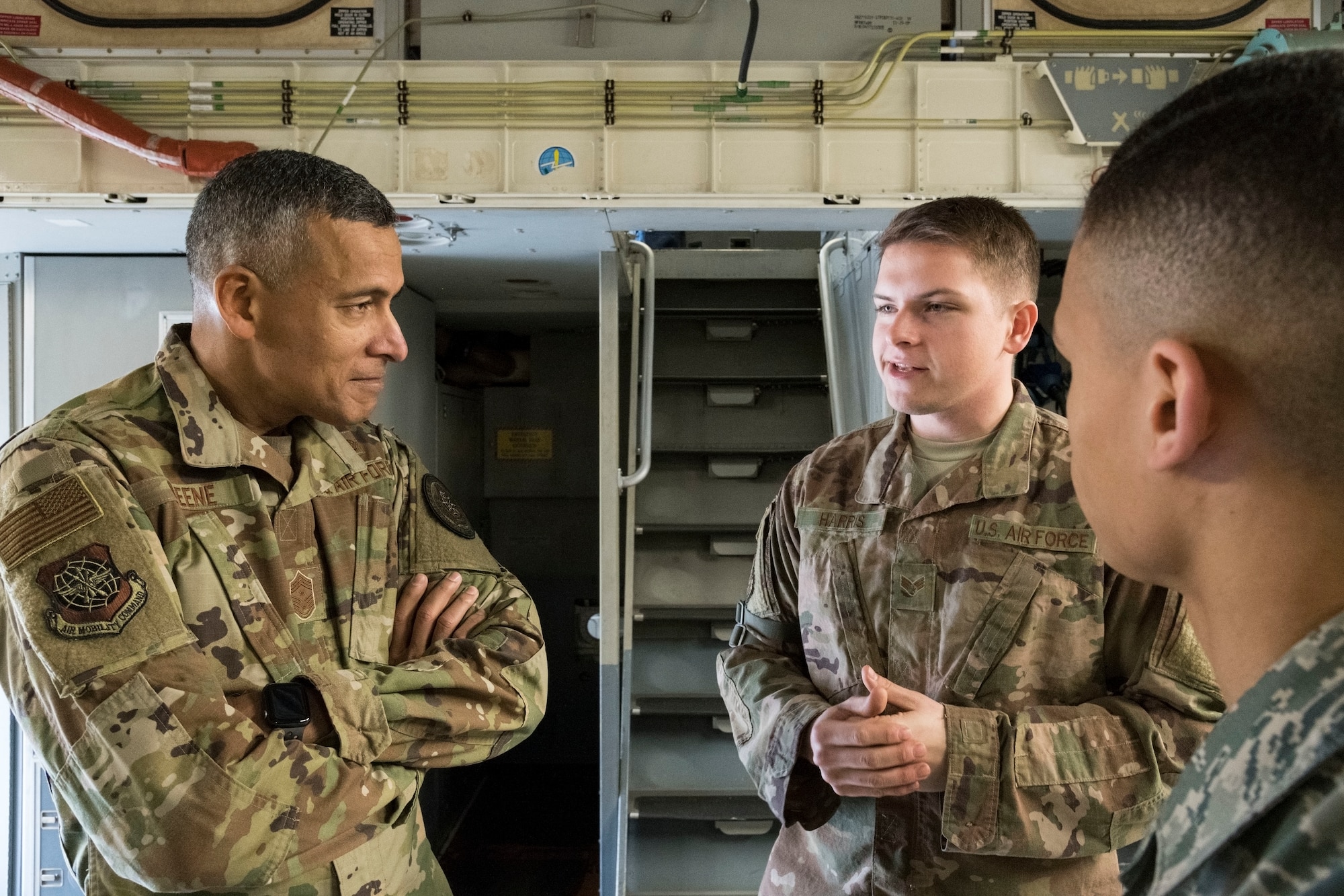 From left, U.S. Air Force Chief Master Sgt. Terrence Greene, command chief of Air Mobility Command, Scott Air Force Base, Ill., speaks with Senior Airman Victor Harris, C-17 Globemaster III aircraft dedicated crew chief (DCC), and Airman 1st Class Jason Thompson, C-17 assistant DCC, both assigned to the 736th Aircraft Maintenance Squadron Feb. 7, 2019, at Dover Air Force Base, Del. Harris and Thompson briefed Greene on the C-17 DCC program. (U.S. Air Force photo by Roland Balik)