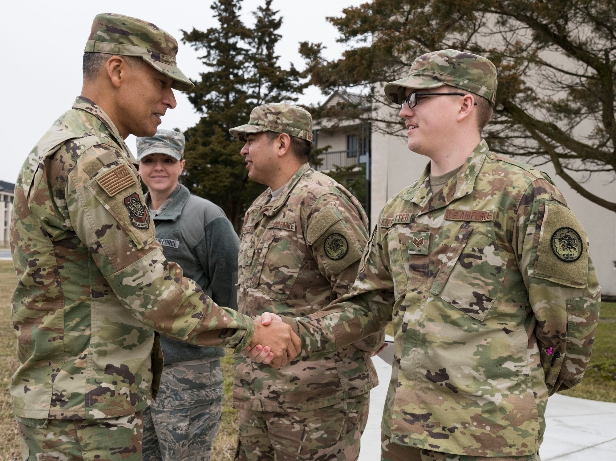 U.S. Air Force Chief Master Sgt. Terrence Greene, command chief of Air Mobility Command, Scott Air Force Base, Ill., shakes hands with Staff Sgt. Anthony Kieswetter, 436th Civil Engineer Squadron Airman dormitory leader, Feb. 7, 2019, at Dover Air Force Base, Del. Also pictured, Master Sgt. Amber Lawrence, unaccompanied housing supervisor, and Staff Sgt. James Hernandez, Airman dormitory leader, both from the 436th CES, informed Greene that Dormitory 401 is the oldest un-renovated dorm on the base. (U.S. Air Force photo by Roland Balik)