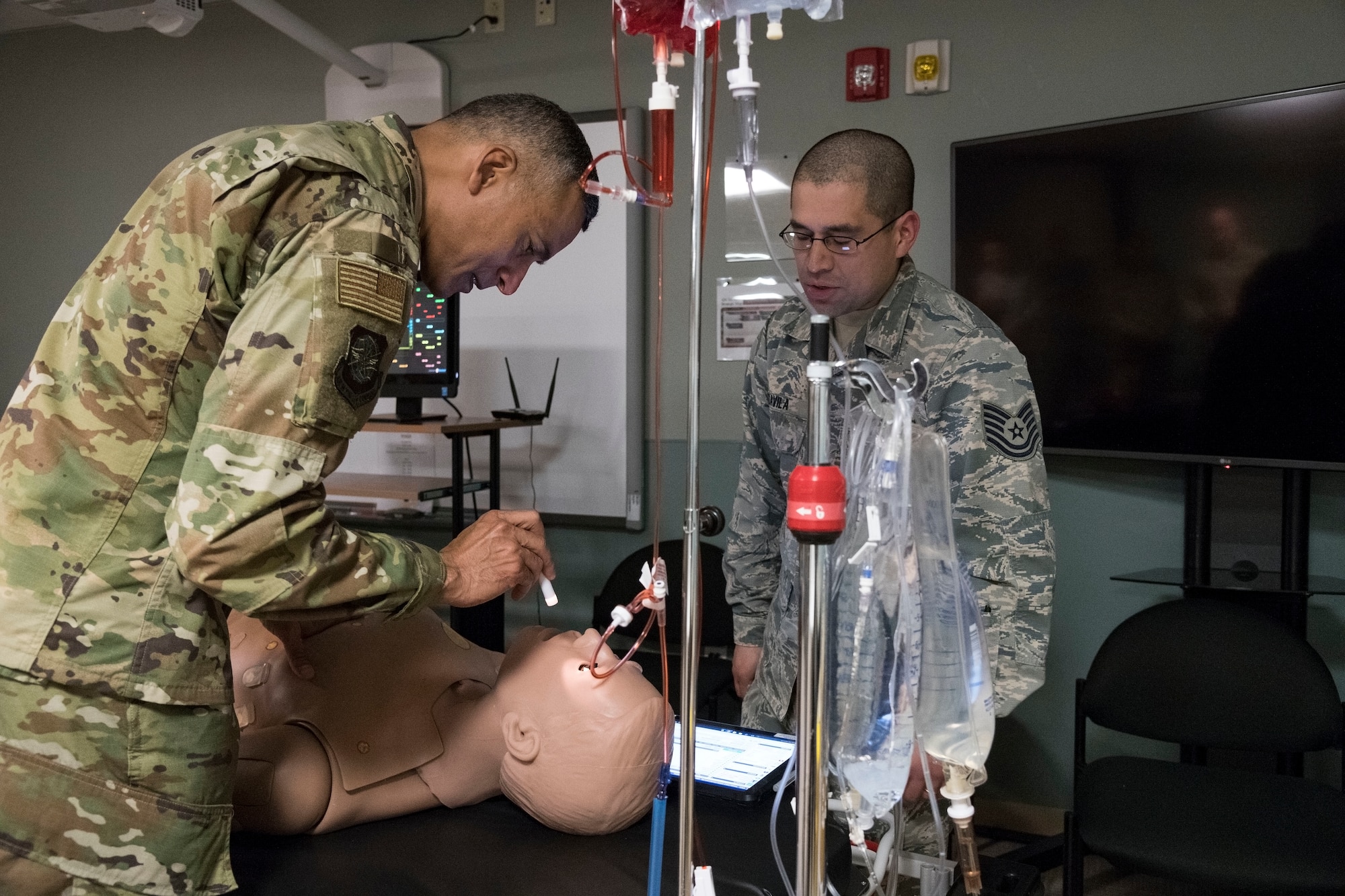 U.S. Air Force Chief Master Sgt. Terrence Greene, command chief of Air Mobility Command, Scott Air Force Base, Ill., checks the pupils on “Trauma Hal” Feb. 7, 2019, at Dover Air Force Base, Del. Tech Sgt. Juan Davila, 436th Aerospace Medicine Squadron medical and operations technician, demonstrated the training capabilities of Trauma Hal during Greene’s visit to the 436th Medical Group. (U.S. Air Force photo by Roland Balik)