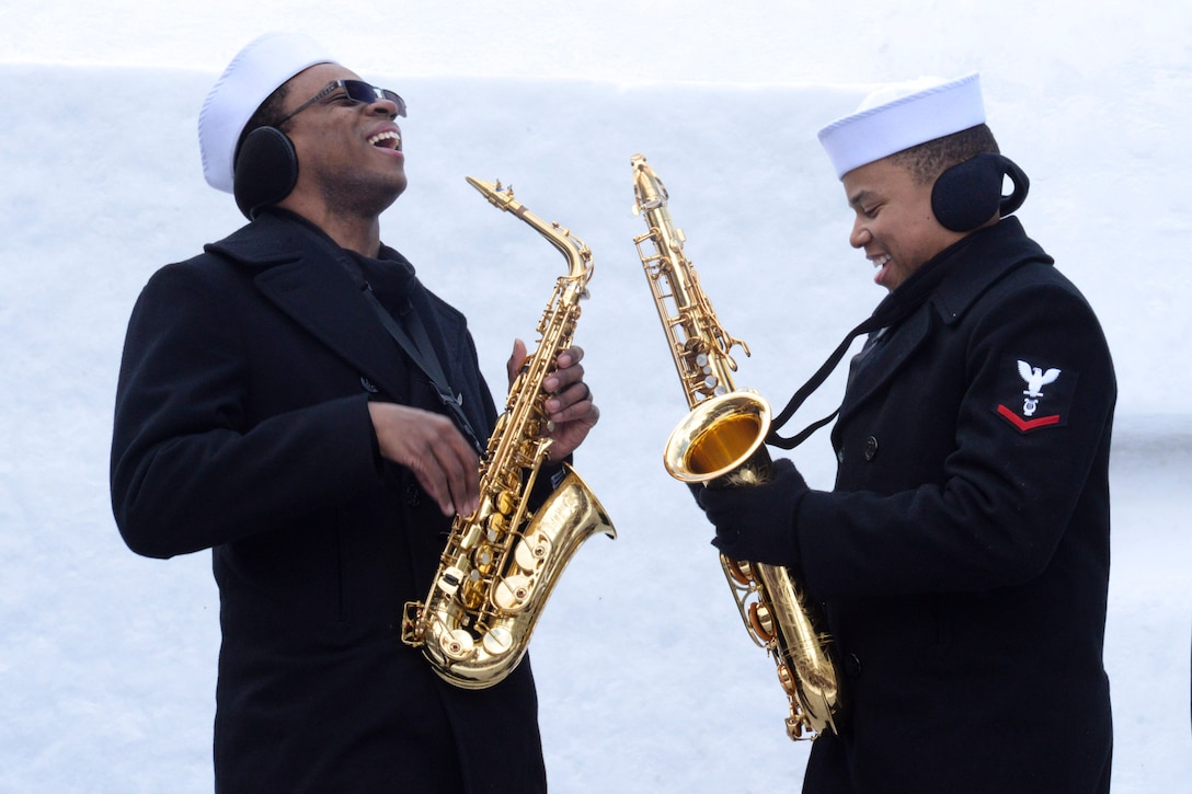 Two sailors playing saxophones.