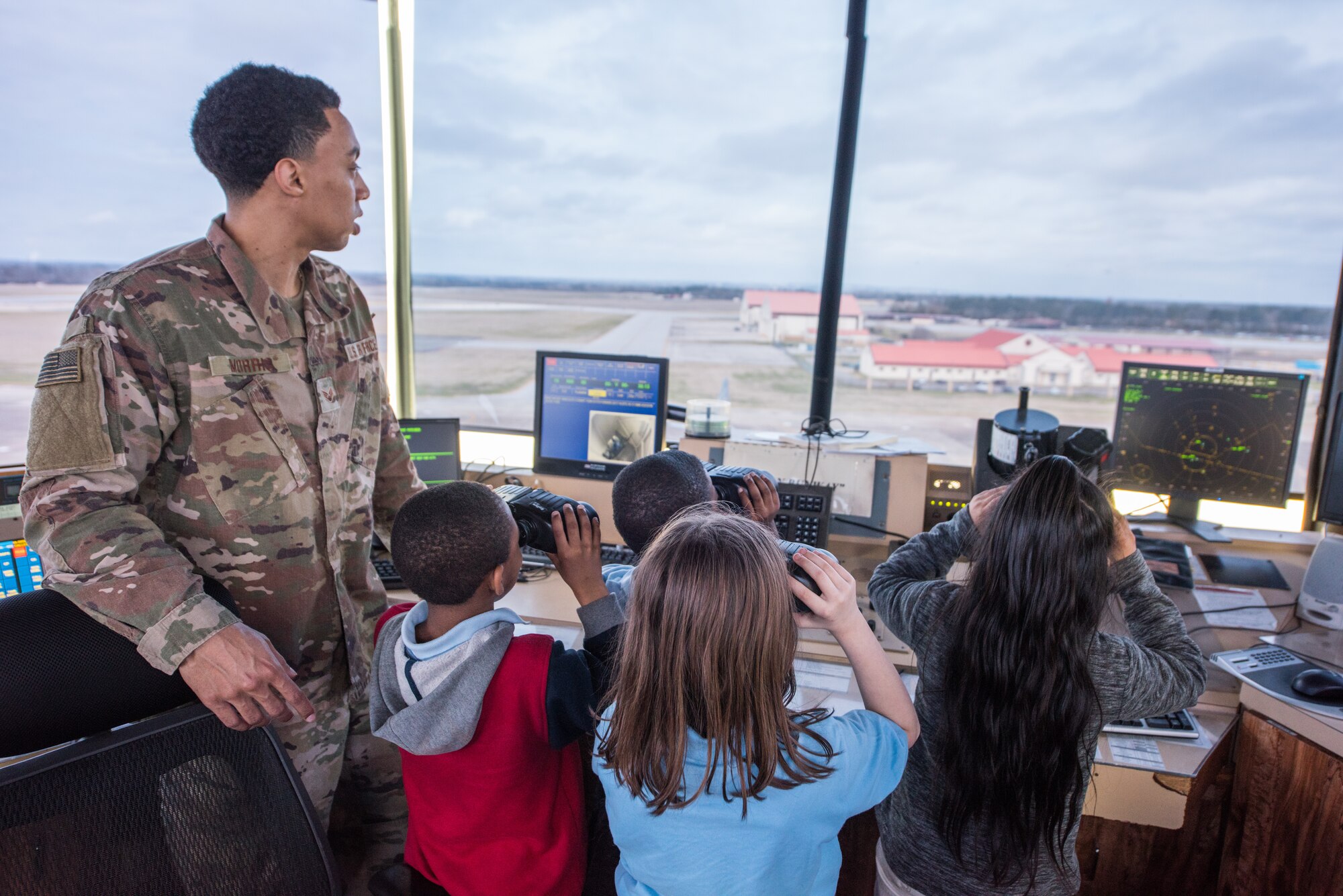 Senior Airman Anthony Morris, 42nd Operational Support Squadron air traffic controller, demonstrates the job of an air traffic controller to a group of third graders from Thelma S. Morris Elementary School Feb. 5, 2019, Maxwell Air Force Base, Alabama. The 42nd OSS invited T.S. Elementary School students and their teachers and gave them the ins and outs of air operations at Maxwell and a tour of the air traffic control tower and a C–130 Hercules. (U.S. Air Force photo by Senior Airman Alexa Culbert)