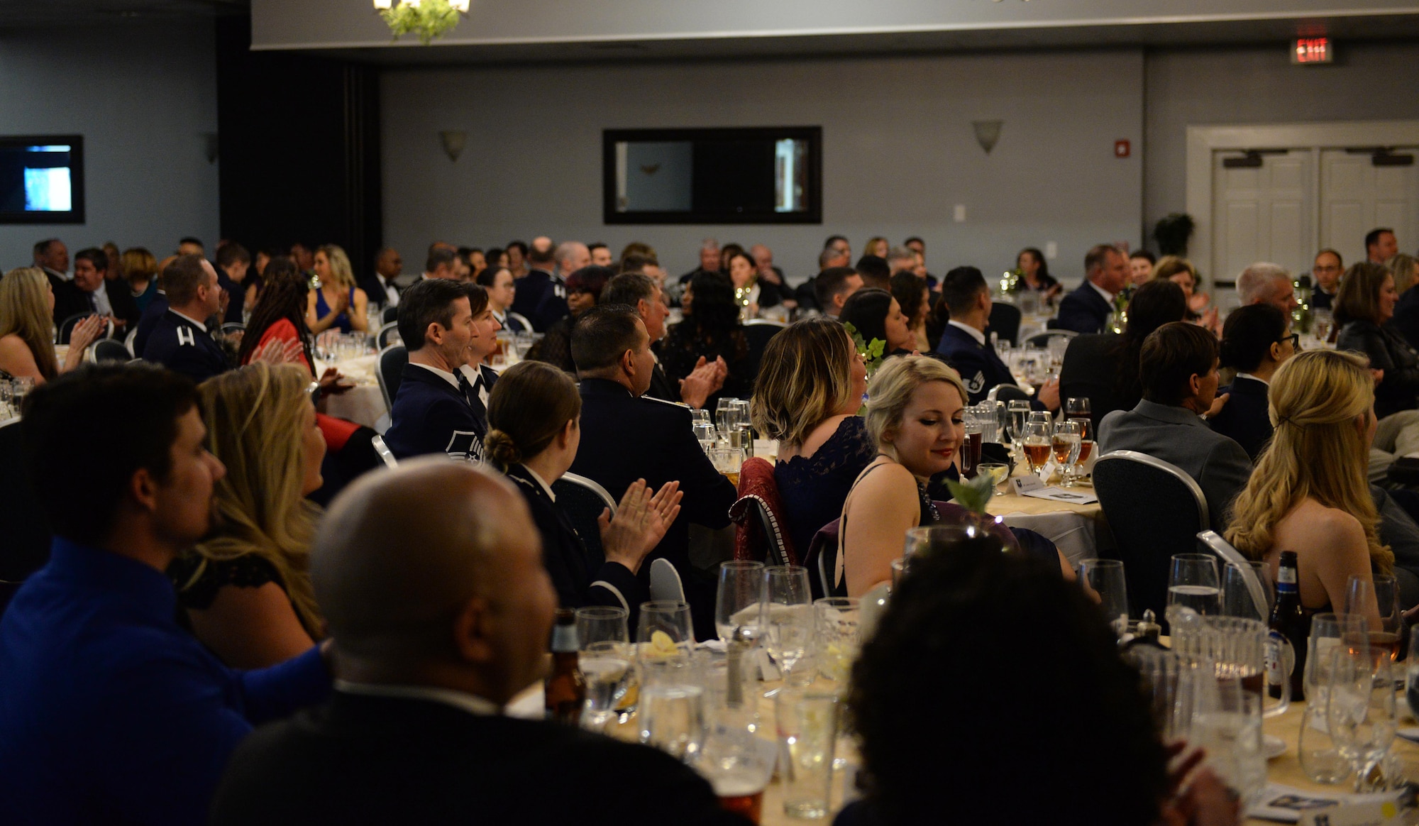 Attendees socialize during dinner at the 14th Flying Training Wing’s 2018 Annual Awards Banquet Feb. 8, 2019, on Columbus Air Force Base, Mississippi. After intermission, attendees were treated to a video, highlighting the importance of the wing mission and the impact Airmen have in a unique interview format. (U.S. Air Force photo by Airman Hannah Bean)