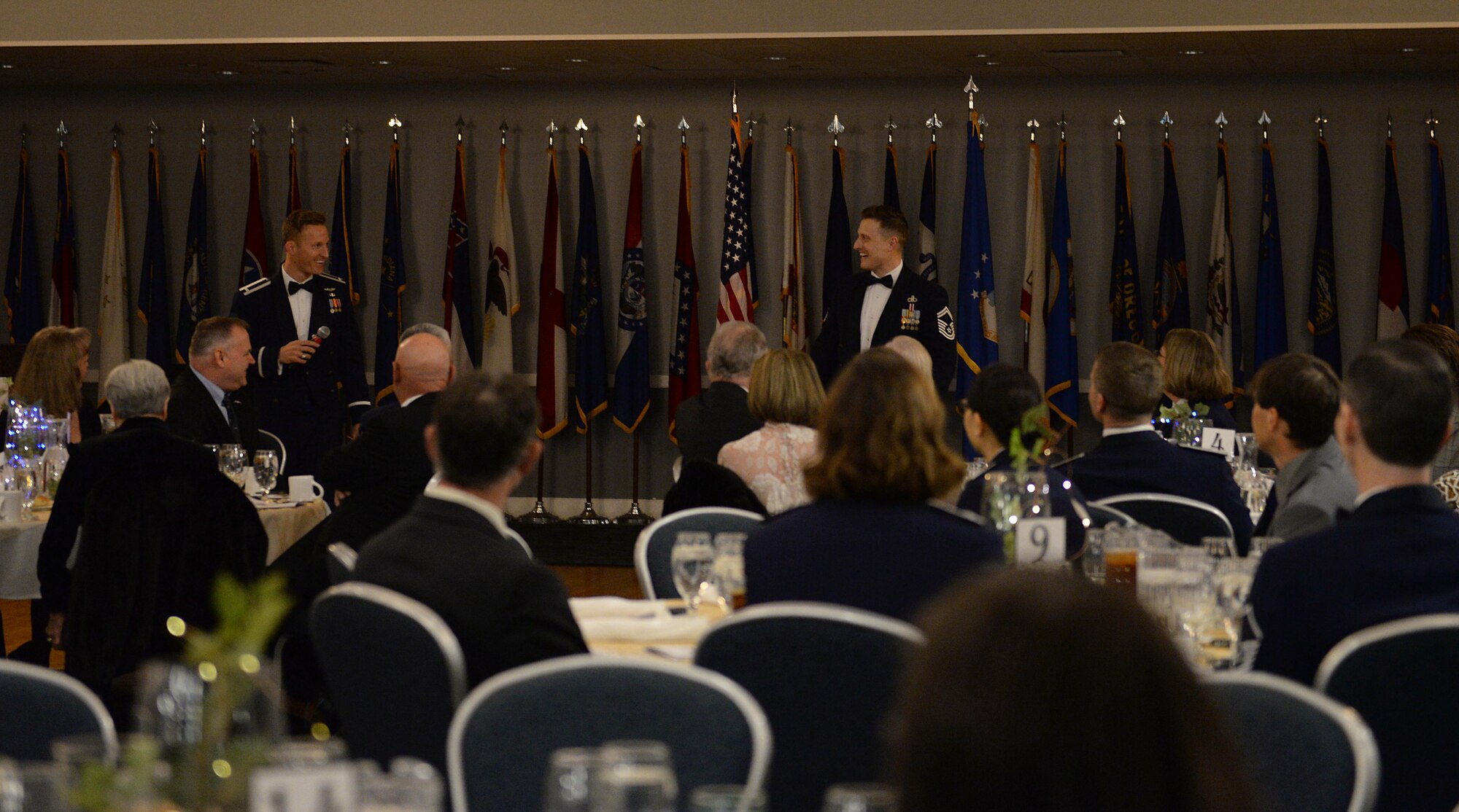 Senior Master Sgt. Garrick, 14th Operations Support Squadron chief controller of air traffic control, and 1st Lt. Dennis Cook, 50th Flying Training Squadron instructor pilot, welcome attendees to the 14th Flying Training Wing’s 2018 Annual Awards Banquet Feb. 8, 2019, at the Club on Columbus Air Force Base, Mississippi. Forty-three members and four teams, which represented 16 categories, were recognized and competed for 16 wing-level awards. (U.S. Air Force photo by Airman Hannah Bean)