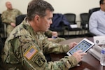 The U.S. Army G1, Lt. Gen. Thomas Seamands, previews the Integrated Personnel and Pay System - Army (IPPS-A) app while visiting Pennsylvania Army National Guard Soldiers at Fort Indiantown Gap Feb. 7.