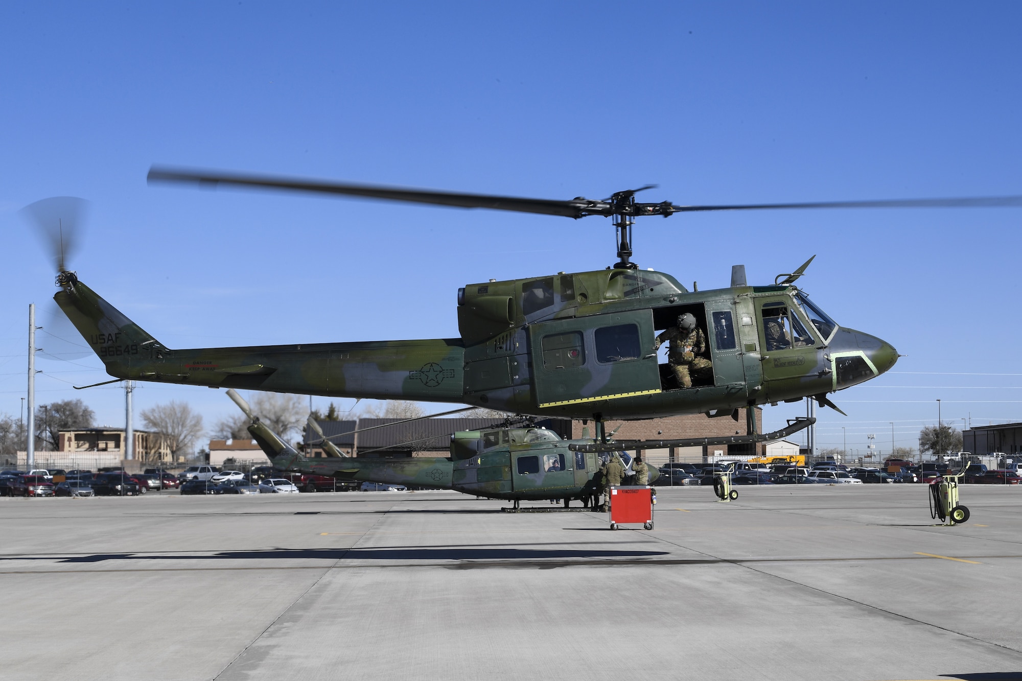 A UH-1N Huey with Maj. Gen. Mark E. Weatherington, Air Education and Training Command deputy commander, and crew members lifts-off the ground.