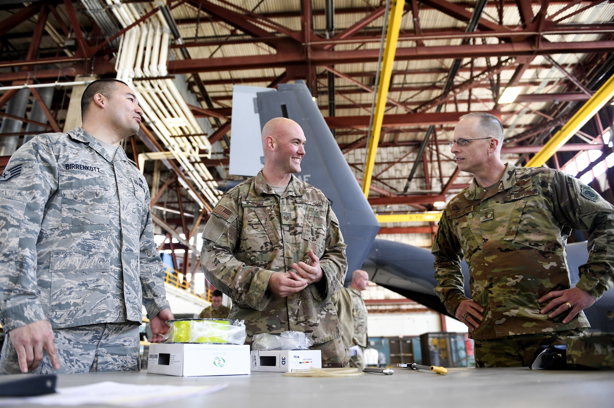 Airmen show deputy commander a new inovative tool.